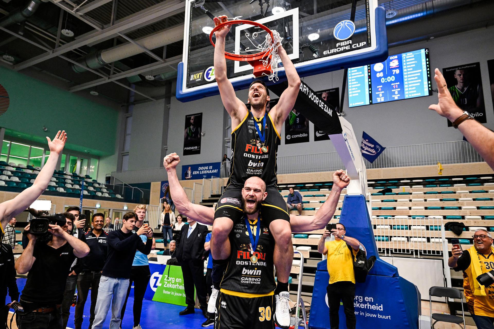 Oostende's Sam Van Rossom and Oostende's Pierre-Antoine Gillet celebrate after winning a basketball match between ZZ Leiden and BC Oostende, Wednesday 12 June 2024 in Leiden, the Netherlands, match 2 (best of 3) of the play-off finals of the 'BNXT League' first division basket championship. Oostende won the first leg. BELGA PHOTO TOM GOYVAERTS
