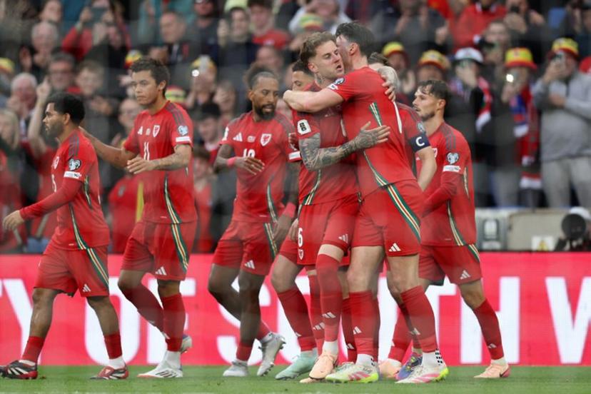 Wales' defender #06 Joe Rodon (C) celebrates with teammates after scoring the first goal during the 2026 World Cup Group J qualifier football match between Wales and Liechtenstein, at Cardiff City Stadium, in Cardiff, on June 6, 2025.   Darren Staples / AFP