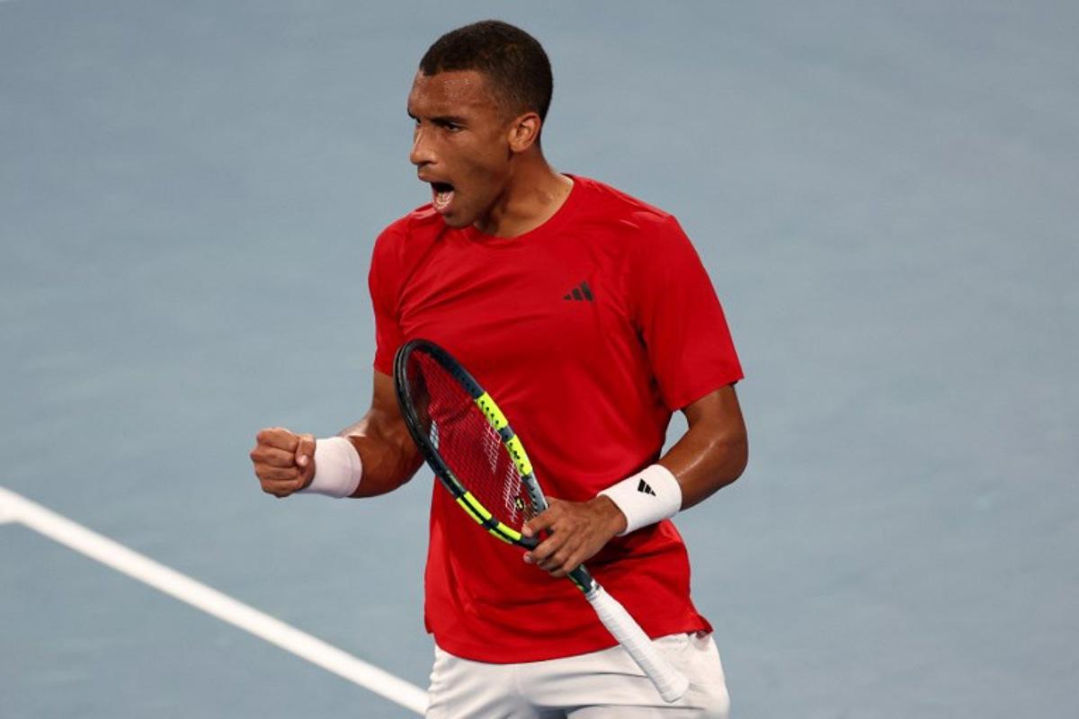 Canada's Felix Auger-Aliassime reacts after winning the first set against China's Zhang Zhizhen during their men's singles match at the United Cup tennis tournament on Ken Rosewood Arena in Sydney on January 4, 2026.  Izhar KHAN / AFP