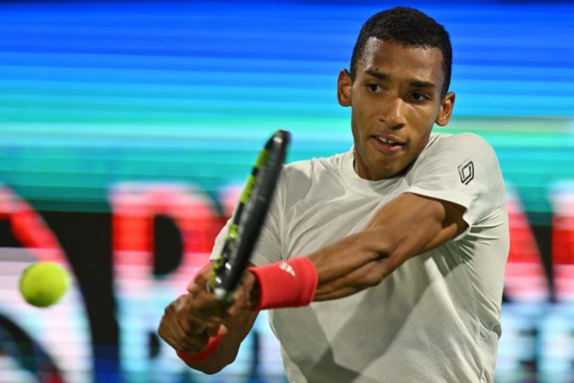 Canada's Felix Auger Aliassime returns the ball to Greece's Stefanos Tsitsipas during the final match of the ATP Dubai Duty Free Tennis Championship in Dubai on March 1, 2025.  Ryan Lim / AFP