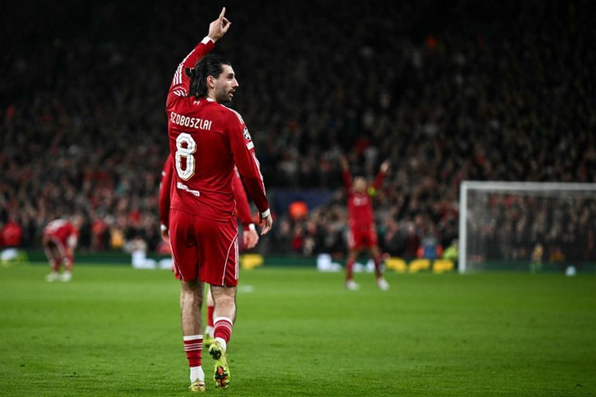 Liverpool's Hungarian midfielder #08 Dominik Szoboszlai celebrates scoring his team's first goal during the UEFA Champions League, round of 16 second leg football match between Liverpool and Galatasaray at Anfield in Liverpool, north-west England on March 18, 2026.  Paul ELLIS / AFP