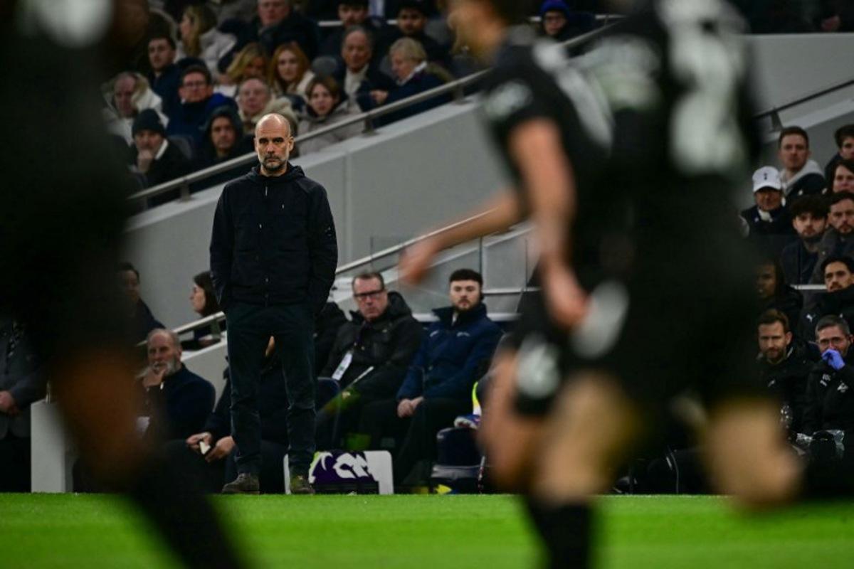 Manchester City's Spanish manager Pep Guardiola (L) watches the action during the English Premier League football match between Tottenham Hotspur and Manchester City at the Tottenham Hotspur Stadium in London, on February 1, 2026.  Ben STANSALL / AFP