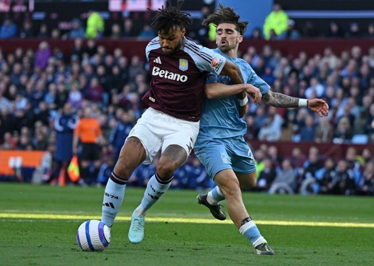 Nottingham Forest's Portuguese striker #20 Jota Silva (R) and Aston Villa's English defender #05 Tyrone Mings vie for the ball during the English Premier League football match between Aston Villa and Nottingham Forest at Villa Park in Birmingham, central England on April 5, 2025.  JUSTIN TALLIS / AFP