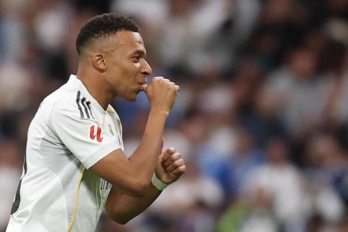 Real Madrid's French forward #10 Kylian Mbappe celebrates the opening goal, eventually disallowed, during the Spanish league football match between Real Madrid CF and FC Barcelona at Santiago Bernabeu Stadium in Madrid on October 26 , 2025.  Oscar DEL POZO / AFP