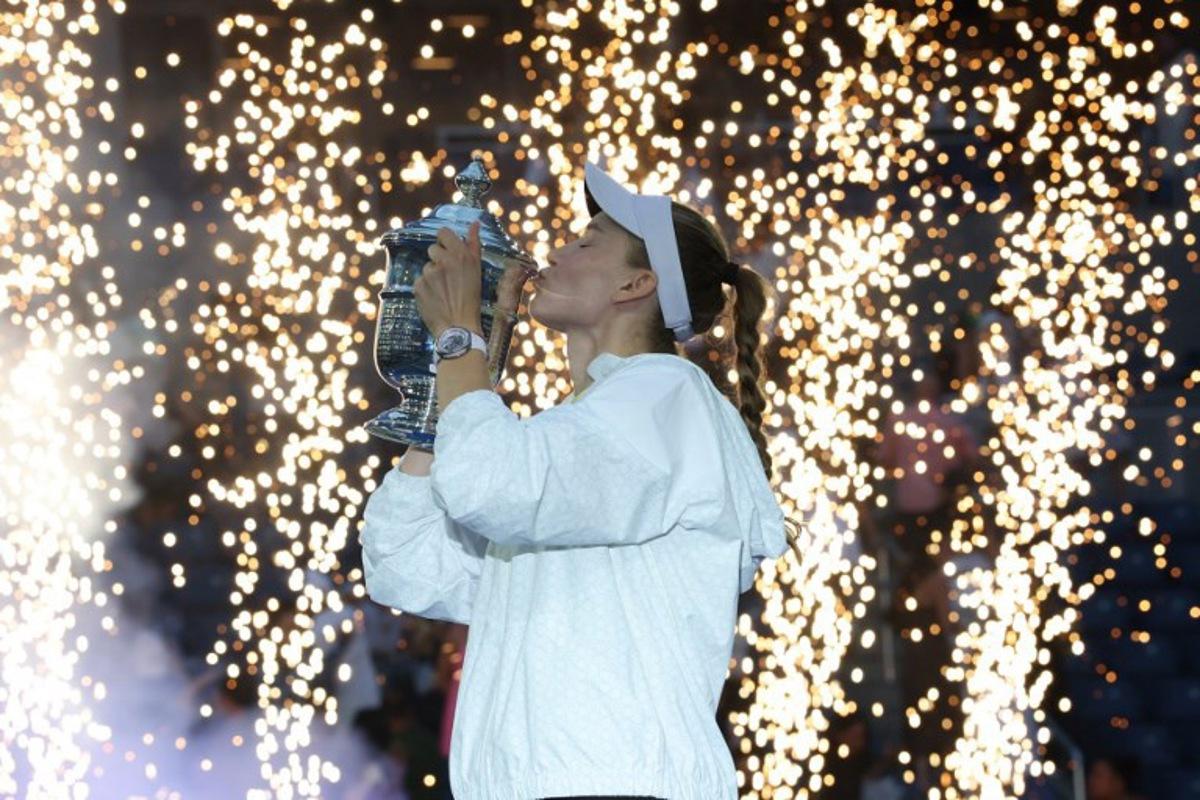 Kazakhstan's Elena Rybakina kisses the winner's trophy after winning the women's singles final tennis match against Belarus's Aryna Sabalenka on day fourteen of the US Open tennis tournament at the USTA Billie Jean King National Tennis Center in New York City on September 12, 2026.  TIMOTHY A. CLARY / AFP