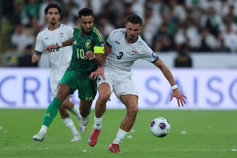 Saudi Arabia's midfielder #10 Salem al-Dawsari is marked by Iraq's defender #3 Hussein Ali during the FIFA World Cup 2026 Asian qualifier football match between Saudi Arabia and Iraq at King Abdullah Sports City in Jeddah on October 14, 2025.  AFP