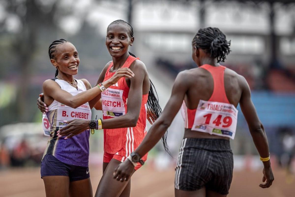 Kenya's Olympic gold medallist and world record holder Beatrice Chebet (L), Kenya's Agnes Jebet Ngetich (C) and Kenya's Janeth Chepngetich (R) celebrate after qualifying in the women's 10000m event of the Kenya trials for Tokyo 2025 world championships at the Ulinzi Sport Complex in Nairobi on July 22, 2025.  Luis TATO / AFP