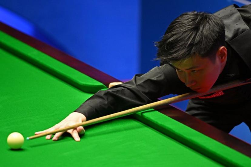 China's Zhao Xintong plays a shot against Scotland's Stephen Maguire during their World Championship Snooker second round match at The Crucible in Sheffield, England on April 22, 2022.   Oli SCARFF / AFP