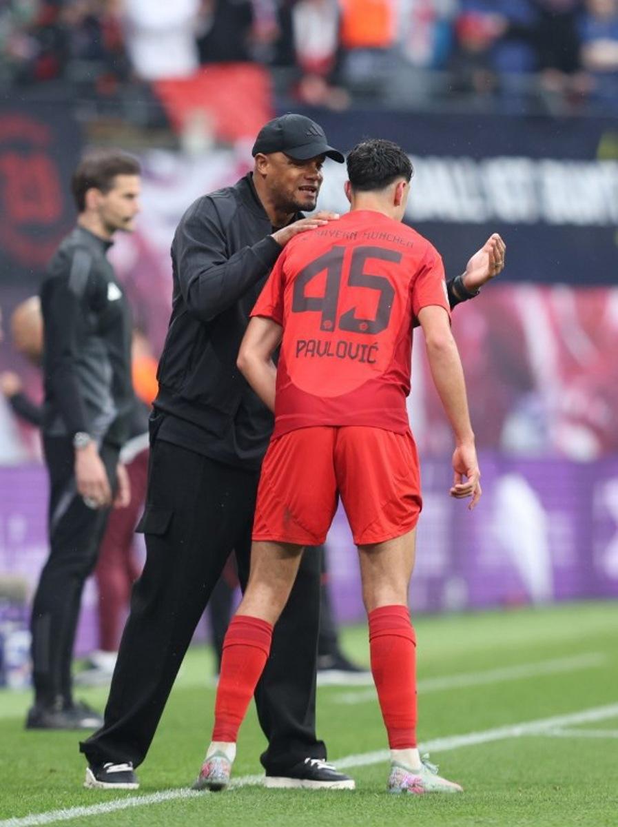 Bayern Munich's Belgian head coach Vincent Kompany (L) talks to Bayern Munich's German midfielder #45 Aleksandar Pavlovic during the German first division Bundesliga football match between RB Leipzig and FC Bayern Munich in Leipzig, eastern Germany on May 3, 2025.  RONNY HARTMANN / AFP