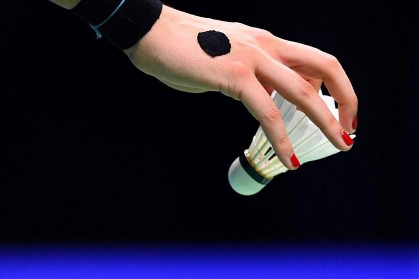 Carolina Marin of Spain holds a shuttlecock in the women's single semifinal match against He Bingjiao of China during the badminton World Championships in Nanjing, Jiangsu province on August 4, 2018.  Johannes EISELE / AFP