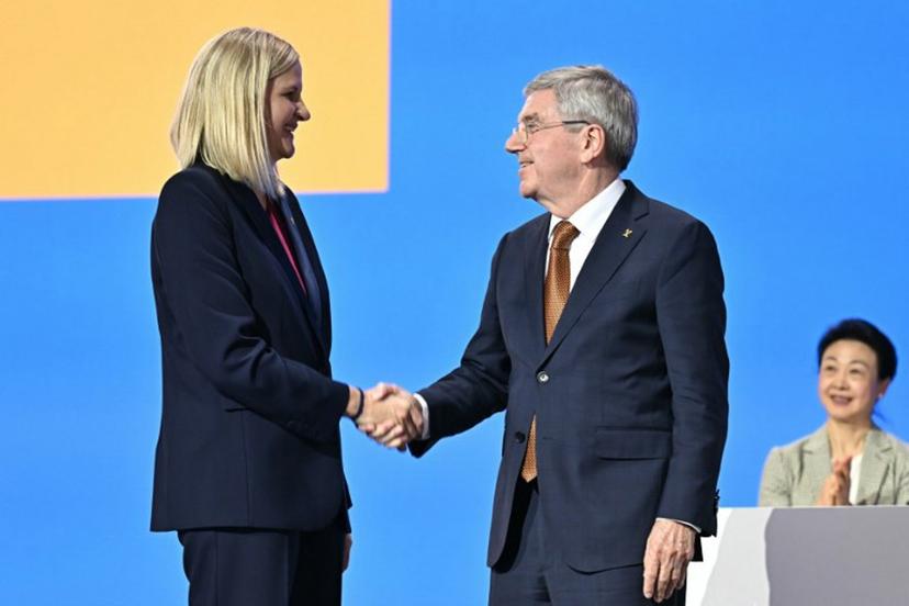 Zimbabwean candidate for the presidency of the International Olympic Committee (IOC) Kirsty Coventry (L) shakes hands with IOC outgoing president Thomas Bach after being elected during the 144th IOC Session on the day of the election of the next President of the International Olympic Committee, in Costa Navarino, Greece on March 20, 2025. Zimbabwe's Kirsty Coventry elected president of International Olympic Committee on March 20, 2025.  Fabrice COFFRINI / AFP