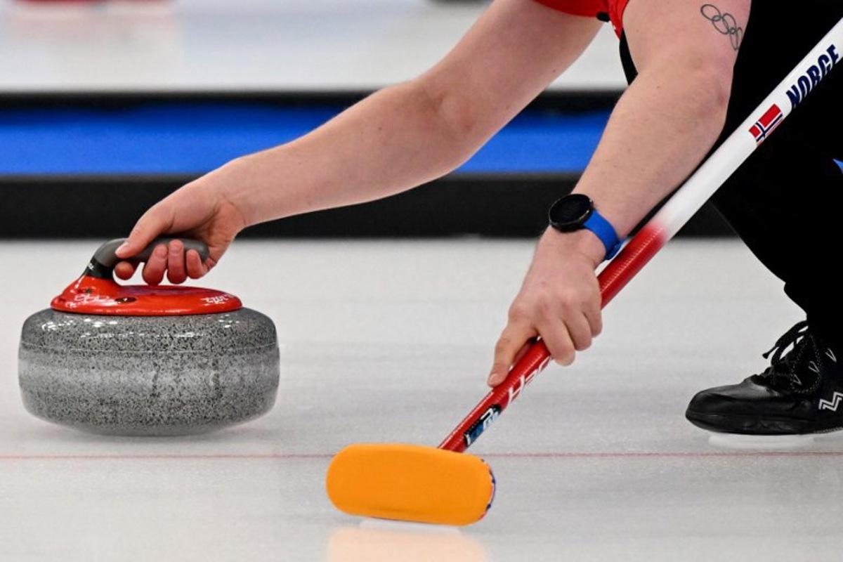 Norway's Magnus Nedregotten curls the stone during the mixed doubles round robin session 9 game of the Beijing 2022 Winter Olympic Games curling competition between Norway and China, at the National Aquatics Centre in Beijing on February 5, 2022.  Lillian SUWANRUMPHA / AFP