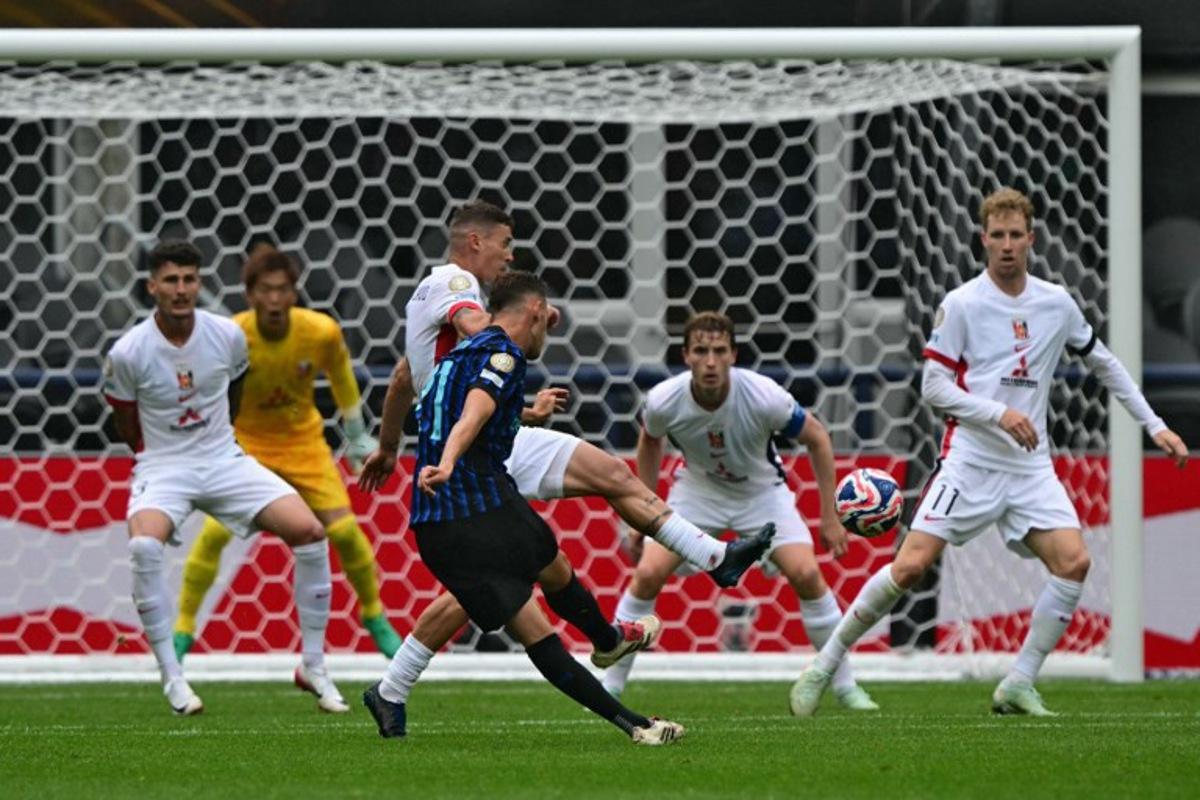 Inter Milan's Albanian midfielder #21 Kristjan Asllani (C) shoots but fails to score during the FIFA Club World Cup 2025 Group E football match between Italy's Inter Milan and Japan's Urawa Red Diamonds at the Lumen Field stadium in Seattle on June 21, 2025.  Pablo PORCIUNCULA / AFP