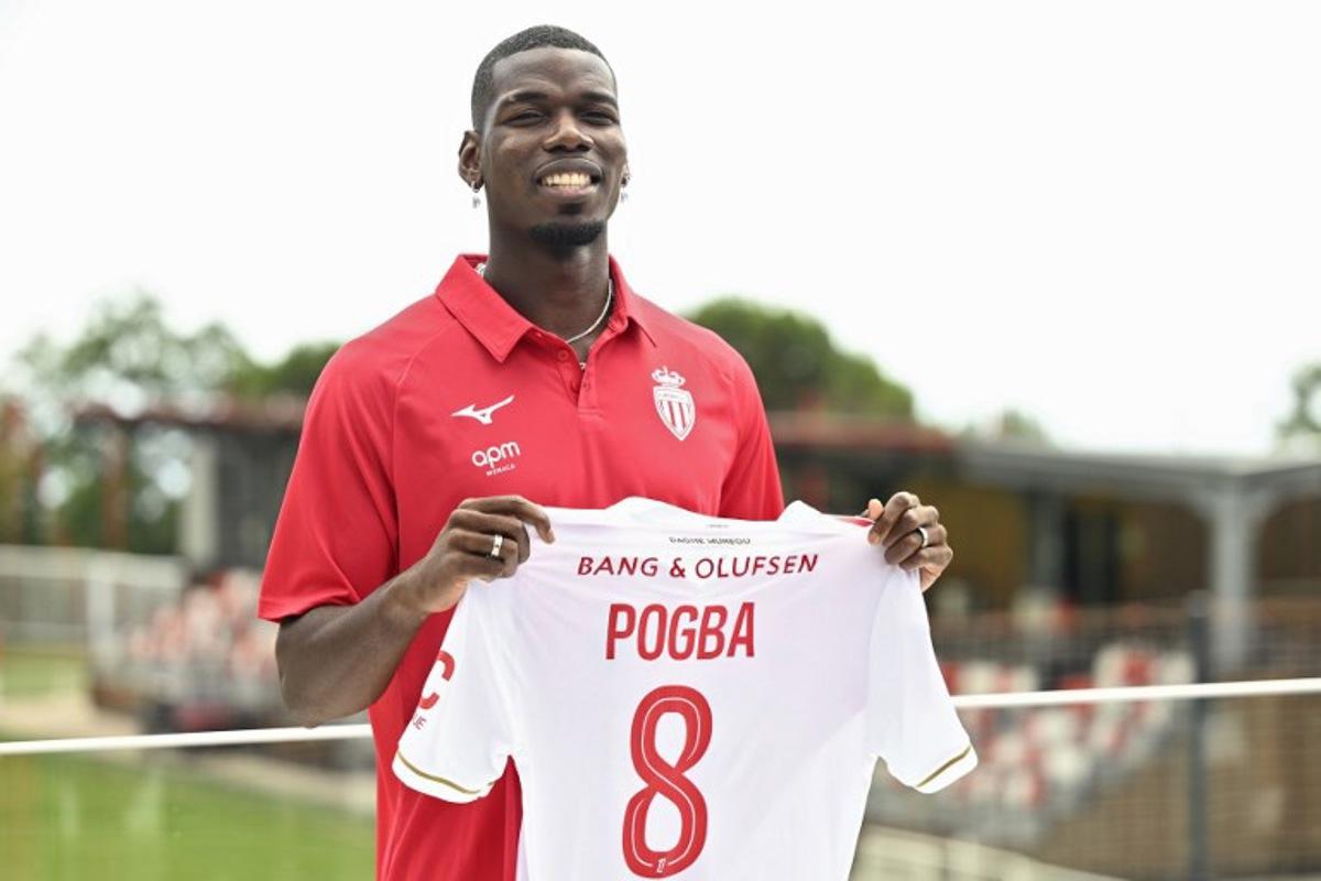 French midfielder Paul Pogba poses with his new jersey following his official presentation in Monaco, on July 3, 2025. Paul Pogba has signed a two-year deal with Ligue 1 side Monaco to return to football after a near two-year absence, the club announced on Juner 28, 2025. Frederic DIDES / AFP