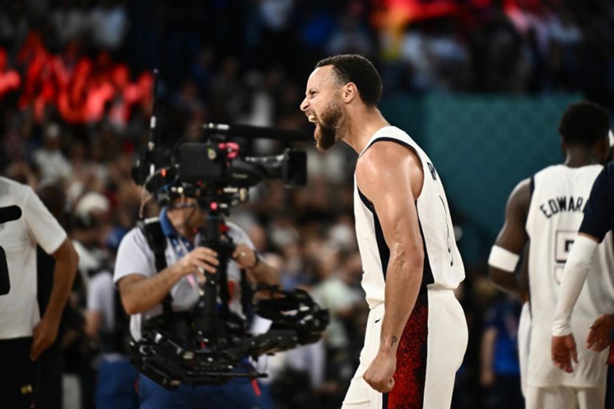 USA's #04 Stephen Curry celebrates after the USA won the men's semifinal basketball match between USA and Serbia during the Paris 2024 Olympic Games at the Bercy  Arena in Paris on August 8, 2024.  Aris MESSINIS / AFP