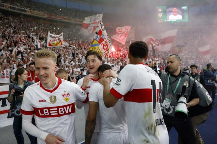 Stuttgart's French midfielder #08 Enzo Millot (C) celebrates scoring his team's fourth goal with teammates and Stuttgart fans during the German Cup (DFB Pokal) final football match between Arminia Bielefeld and VfB Stuttgart at the Olympic Stadium in Berlin on May 24, 2025.  Odd ANDERSEN / AFP