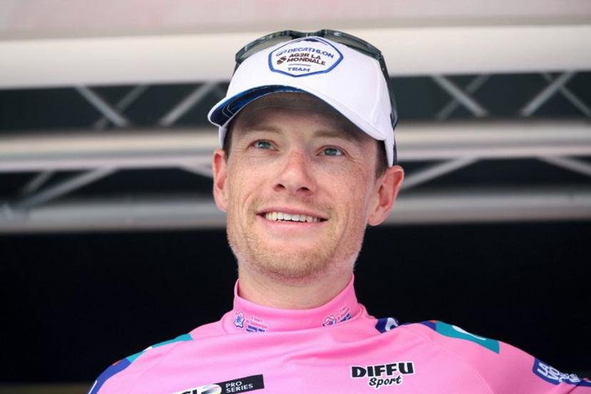 Decathlon AG2R La Mondiale's Irish rider Sam Bennett, wearing the overall leaders pink jersey, celebrates on the podium after the fifth stage of the "4 jours de Dunkerque" (Four days of Dunkirk) cycling race, 179 km from Arques to Cassel, in north France, on May 18, 2024.  FRANCOIS LO PRESTI / AFP