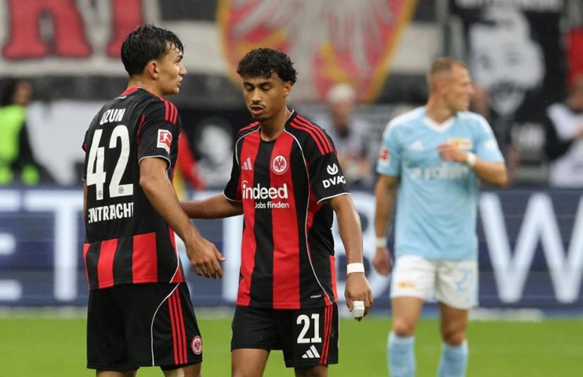 Frankfurt's Turkish forward #42 Can Uzun (L) celebrates with Frankfurt's German defender #21 Nathaniel Brown scoring during the German first division Bundesliga football match between Eintracht Frankfurt and 1 FC Union Berlin in Frankfurt am Main, western Germany on September 21, 2025.  Daniel ROLAND / AFP