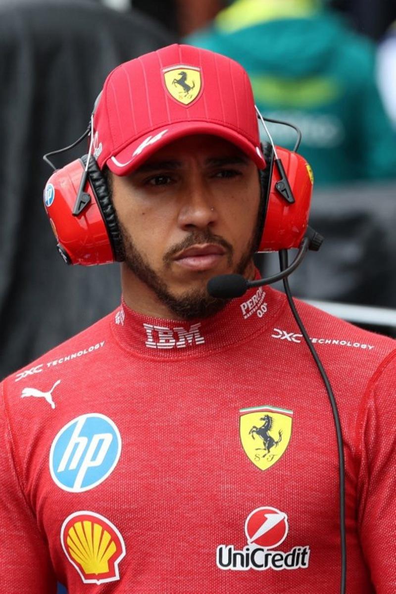 Ferrari's British driver Lewis Hamilton looks on after a red flag due to visibility delayed the start of the Formula One Belgian Grand Prix at the Spa-Francorchamps circuit in Spa, on July 27, 2025.   YVES HERMAN / POOL / AFP