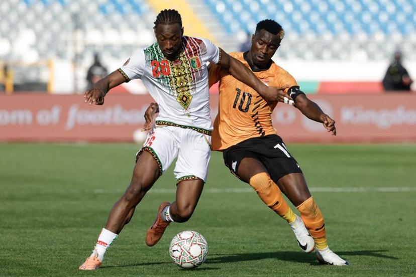 Mali's defender #26 Woyo Coulibaly (L) fights for the ball with Zambia's forward #10 Fashion Sakala (R) during the Africa Cup of Nations (AFCON) Group A football match between Mali and Zambia at Mohammed V Stadium in Casablanca, Morocco on December 22, 2025.   Abdel Majid BZIOUAT / AFP