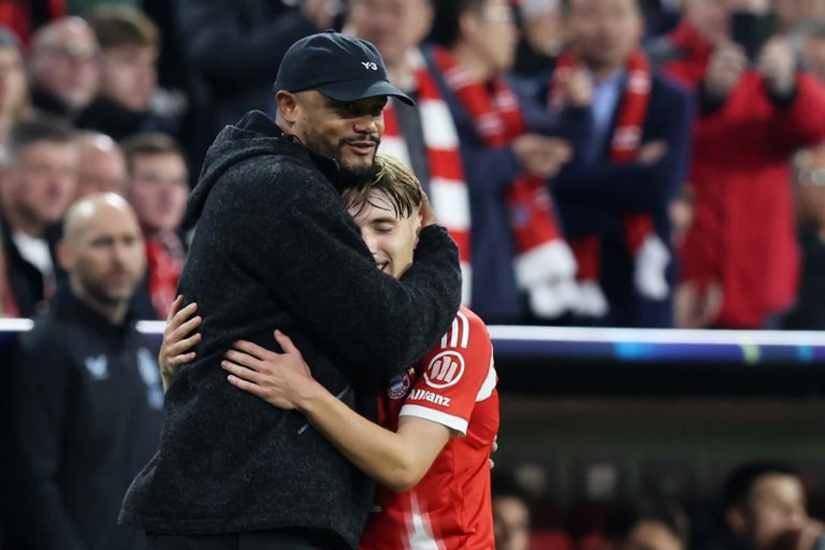Bayern Munich's Belgian head coach Vincent Kompany (L) reacts with Bayern Munich's German midfielder #42 Lennart Karl after Karl left the pitch during the UEFA Champions League football match between FC Bayern Munich and Club Brugge in Munich, southern Germany on October 22, 2025.  Alexandra BEIER / AFP