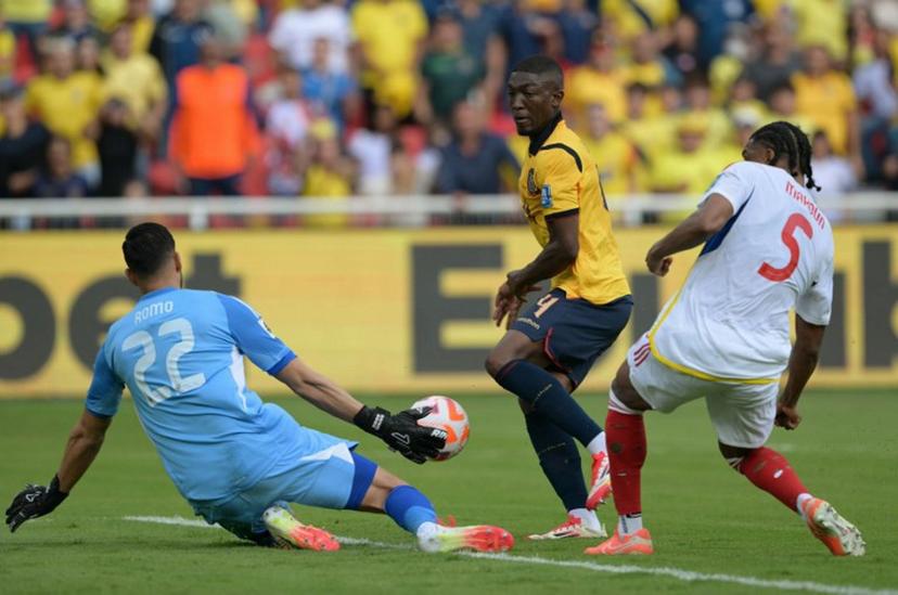 Venezuela's goalkeeper #22 Rafael Romo stops the ball past Ecuador's defender #04 Joel Ordonez (C) and Venezuela's defender #05 Christian Makoun during the 2026 FIFA World Cup South American qualifiers football match between Ecuador and Venezuela, at the Rodrigo Paz Delgado stadium in Quito, on March 21, 2025.  Rodrigo BUENDIA / AFP