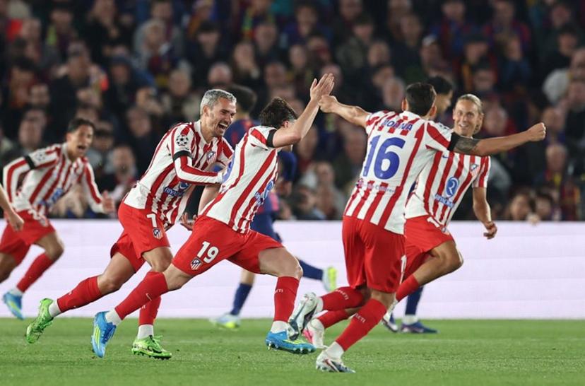 Atletico Madrid's Argentine forward #19 Julian Alvarez (R) celebrates scoring his team's first goal with teammates during the UEFA Champions League quarter final first leg football match between FC Barcelona and Club Atletico de Madrid at Camp Nou Stadium in Barcelona on April 8, 2026.  Josep LAGO / AFP