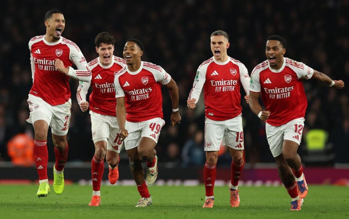 Arsenal's French defender #02 William Saliba (L), Arsenal's Danish defender #16 Christian Norgaard, Arsenal's English midfielder #49 Myles Lewis-Skelly, Arsenal's Belgian midfielder #19 Leandro Trossard and Arsenal's Dutch defender #12 Jurrien Timber celebrate at winning the English League Cup quarter-final football match between Arsenal and Crystal Palace at the Emirates Stadium, in London on December 23, 2025.  Adrian Dennis / AFP