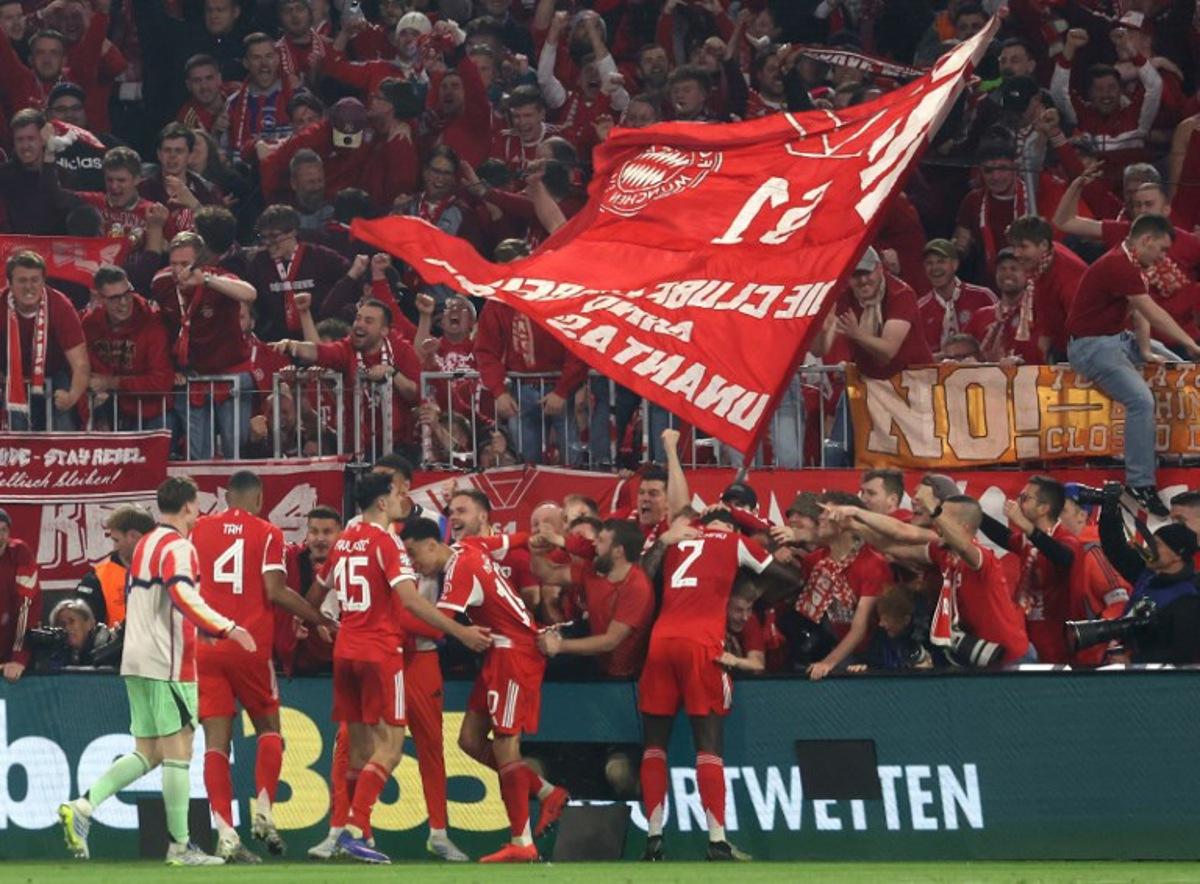 Fans enter the Photographers zone to celebrate with the Bayern Munich team after the UEFA Champions League quarter-final second leg football match between FC Bayern Munich and Real Madrid in Munich, southern Germany, on April 15, 2026.  Karl-Josef HILDENBRAND / AFP