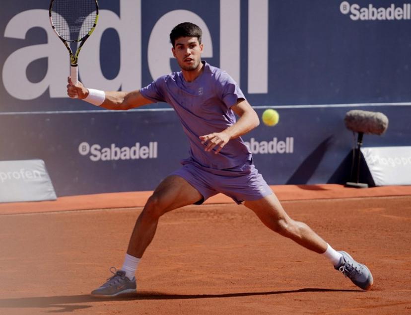 Spain's Carlos Alcaraz returns the ball to Denmark's Holger Rune during the ATP Barcelona Open "Conde de Godo" tennis tournament singles final match at the Real Club de Tenis in Barcelona, on April 20, 2025.  Manaure Quintero / AFP