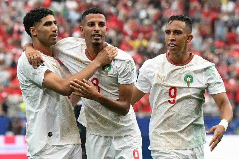 Morocco's midfielder #08 Azzedine Ounahi (C) celebrates scoring his team's first goal with teammates defender #02 Achraf Hakimi (L) and forward #09 Soufiane Rahimi (R) during the 2026 World Cup round of 16 football match between Canada and Morocco at the Houston Stadium in Houston on July 4, 2026.   RONALDO SCHEMIDT / AFP