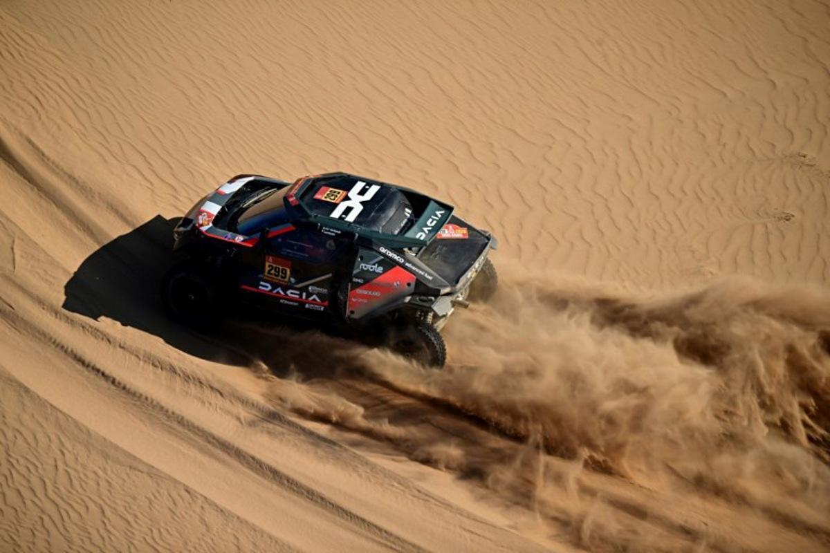 The Dacia Sandriders' Qatari driver Nasser Al-Attiyah and Belgian co-pilot Fabian Lurquin compete in Stage 9, a marathon stage, of the 48th edition of the Dakar Rally 2026, between Wadi ad-Dawasir and Bisha, Saudi Arabia, on January 13, 2026.  Giuseppe CACACE / AFP