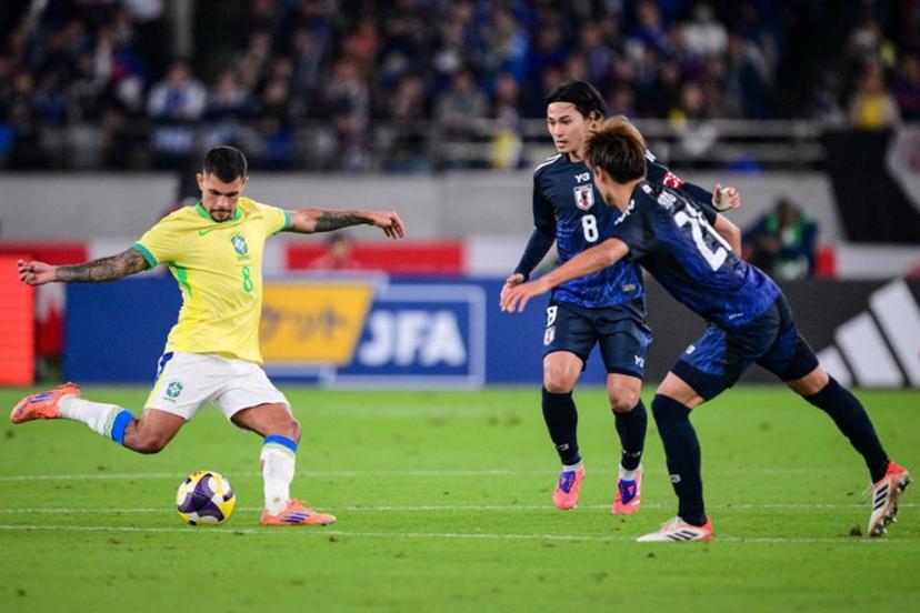 Brazil's midfielder Bruno Guimaraes (L) kicks the ball during the international football friendly match between Japan and Brazil at the Tokyo stadium in Chofu, Tokyo prefecture on October 14, 2025.  Yuichi YAMAZAKI / AFP