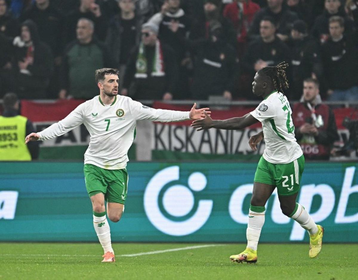 Ireland's forward #07 Troy Parrott (L) celebrates his 2-2 with Ireland's defender #21 Festy Ebosele during the FIFA World Cup 2026 Group F European qualification football match betweem Hungary and Republic of Ireland at the Puskas Arena in Budapest, Hungary on November 16, 2025.   Attila KISBENEDEK / AFP