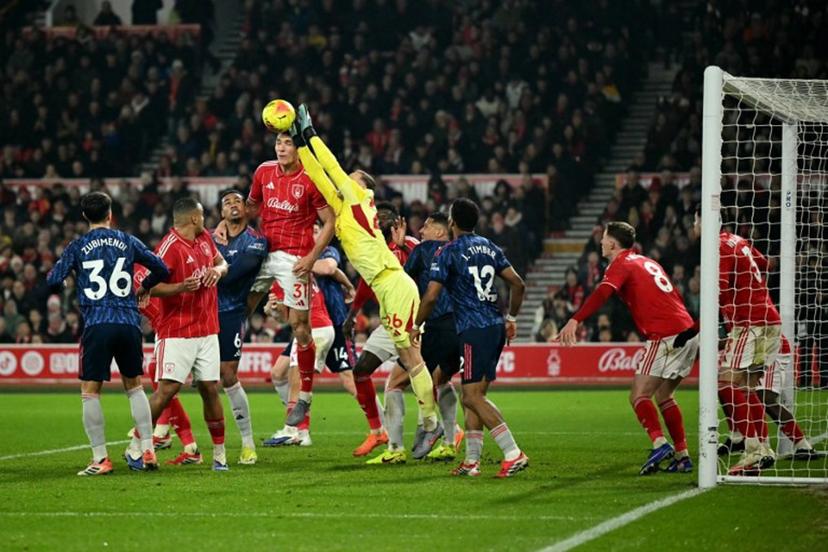Nottingham Forest's Belgian goalkeeper #26 Matz Sels punches the ball away during the English Premier League football match between Nottingham Forest and Arsenal at The City Ground in Nottingham, central England, on January 17, 2026.  JUSTIN TALLIS / AFP