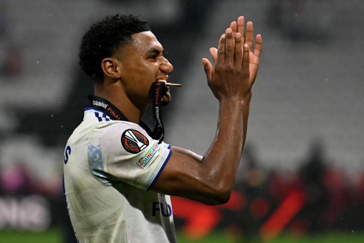 Aston Villa's English striker #11 Ollie Watkins applauds the fans with his winner's medal between his teeth after winning the UEFA Europa League final football match between SC Freiburg and Aston Villa at Besiktas Park in Istanbul on May 20, 2026.  Ozan KOSE / AFP