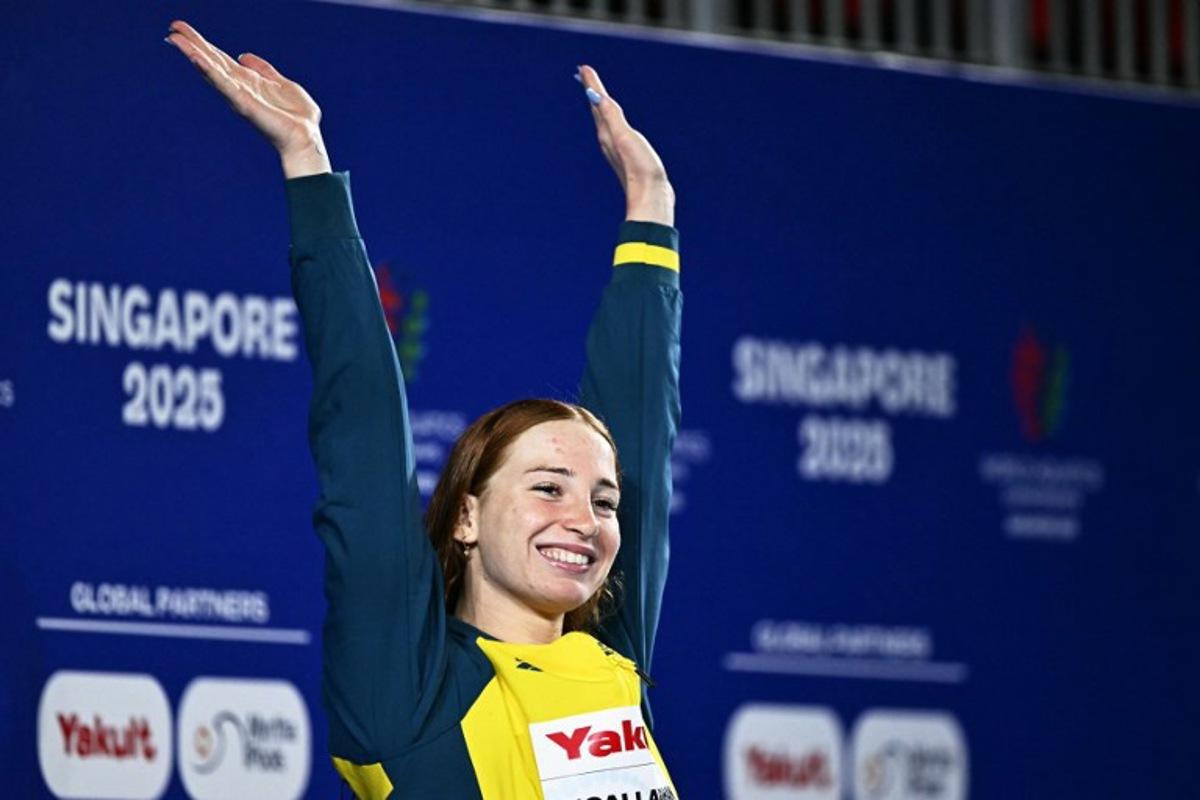 Gold medallist Australia's swimmer Mollie O'Callaghan celebrates on the podium of the women's 200m freestyle swimming event during the 2025 World Aquatics Championships in Singapore on July 30, 2025.   MANAN VATSYAYANA / AFP