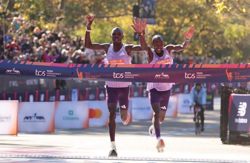 Kenyans Benson Kipruto (L) and Alexander Mutiso celebrate taking first and second place respectively in the New York Marathon in New York on November 2, 2025.  CHARLY TRIBALLEAU / AFP