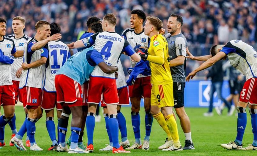 Hamburger SV players celebrate at the end of the Bundesliga second division football match Hamburger SV vs FC St Pauli in Hamburg, northern Germany, on May 3, 2024.  Hamburger SV won the match 1-0. Axel Heimken / AFP