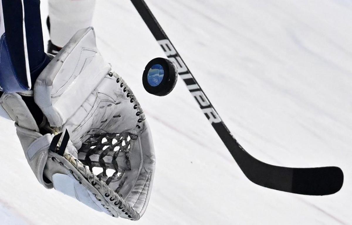 Finland's goaltender Harri Sateri catches the puck during the men's play-off quarterfinal match of the Beijing 2022 Winter Olympic Games ice hockey competition against Switzerland, at the National Indoor Stadium in Beijing on February 16, 2022.  ANTHONY WALLACE / AFP