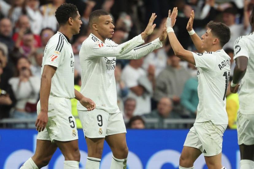 Real Madrid's French forward #09 Kylian Mbappe celebrates scoring his team's second goal, with Real Madrid's English midfielder #05 Jude Bellingham and Real Madrid's Turkish midfielder #15 Arda Guler (R), during the Spanish league football match between Real Madrid CF and RC Celta de Vigo at Santiago Bernabeu Stadium in Madrid on May 4, 2025.  Pierre-Philippe MARCOU / AFP