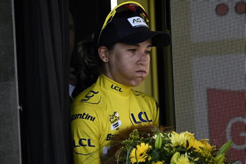 AG Insurance - Soudal Team's Mauritius rider Kimberley Le Court Pienaar reacts after celebrating her overall leader yellow jersey on the podium after the 7th stage (out of 9) of the fourth edition of the Women's Tour de France cycling race, 159.7 km from Bourg-en-Bresse to Chambéry, in Chambéry, south-eastern France on August 1, 2025.  JULIEN DE ROSA / AFP
