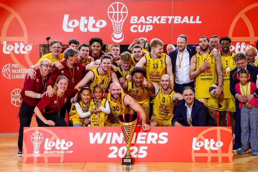 Oostende's players celebrate on the podium after winning a basketball match between BC Oostende and Leuven Bears, Sunday 09 March 2025 in Oostende, the final of the men's Belgian Basketball Cup. BELGA PHOTO KURT DESPLENTER