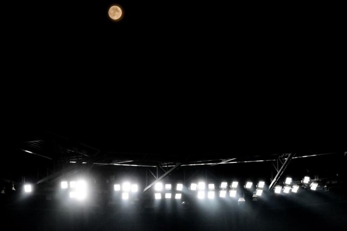 This photograph shows a view of the full moon during the UEFA Champions League qualifying playoff - second leg football match between Olympique Lyonnais (OL) and Fenerbahce SK over  the Groupama Stadium in Decines-Charpieu, central-eastern France, on August 26, 2026.  OLIVIER CHASSIGNOLE / AFP