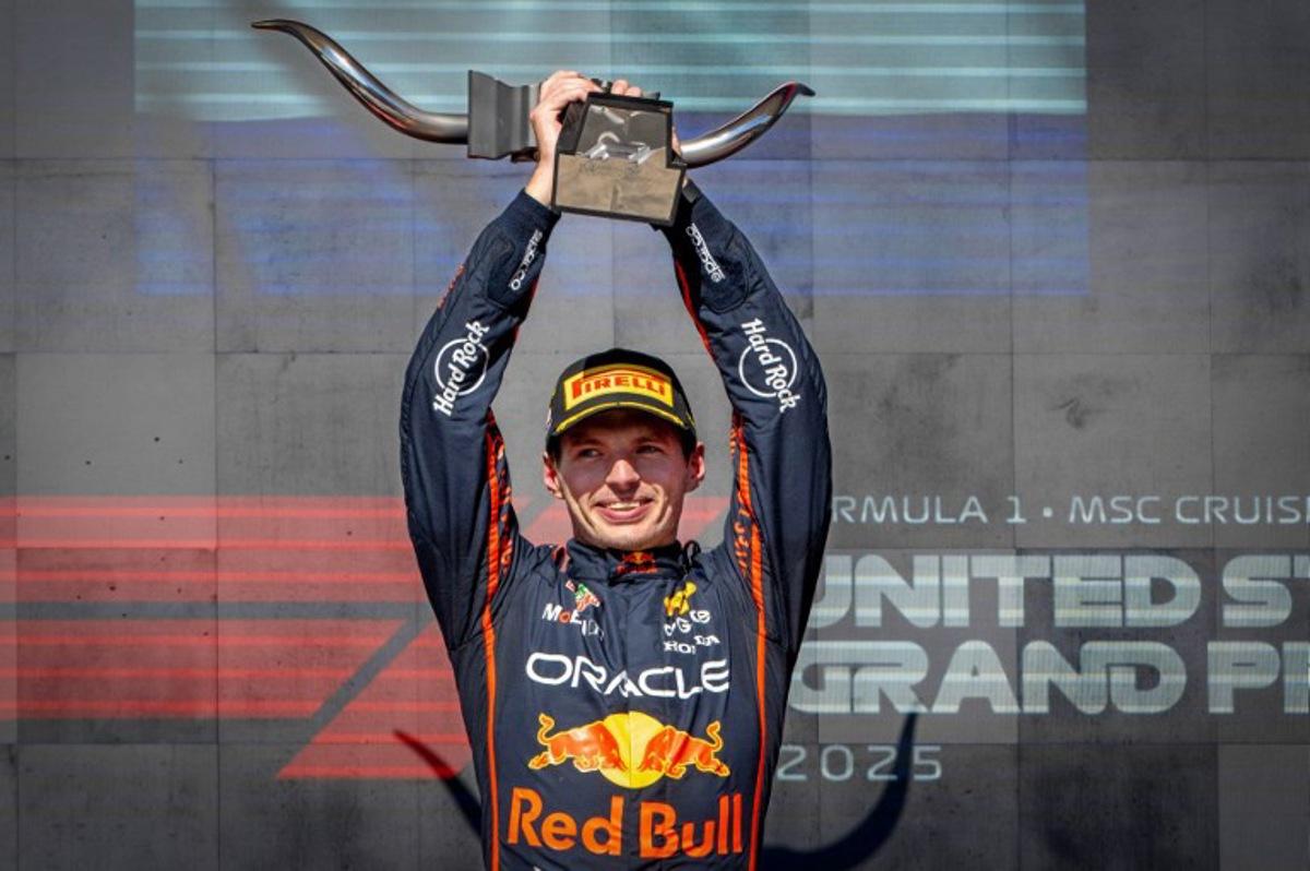 Red Bull Racing's Dutch driver Max Verstappen hoists the trophy on the podium after winning the United States Formula One Grand Prix at the Circuit of the Americas in Austin, Texas, on October 19, 2025.  Jim WATSON / AFP