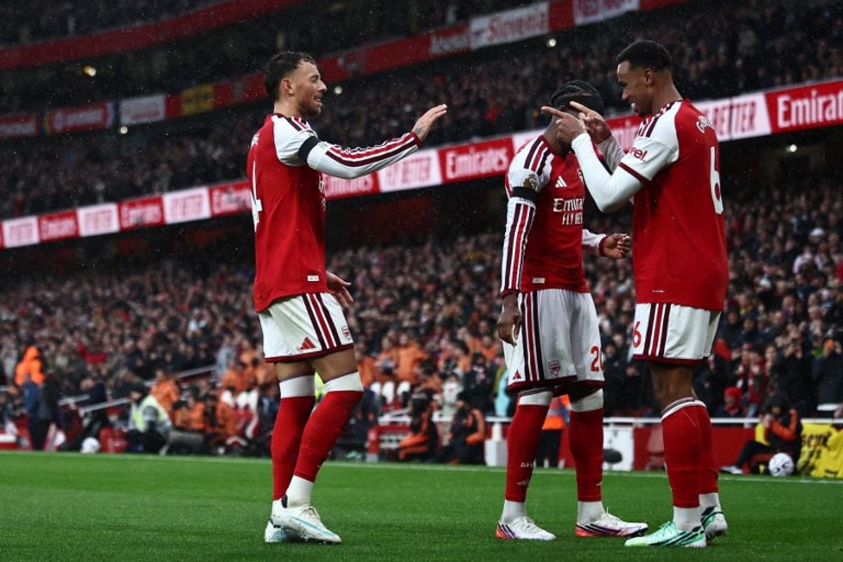 Arsenal's Brazilian defender #06 Gabriel Magalhaes (R) celebrates with Arsenal's English defender #04 Ben White (L) after scoring their second goal during the English Premier League football match between Arsenal and Everton at the Emirates Stadium in London on October 24, 2026.   Henry Nicholls / AFP