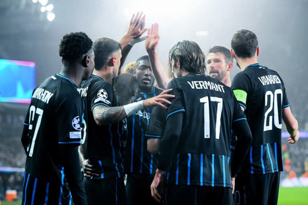 Club Brugge's Belgian forward #17 Romeo Vermant (3R) celebrates with teammates after scoring his team's second goal during the UEFA Champions League, league phase day 8, football match between Club Brugge KV and Olympique de Marseille, at the Jan Breydel Stadium in Bruges on January 28, 2026.  NICOLAS TUCAT / AFP