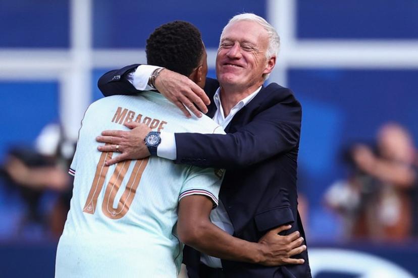 France's forward #10 Kylian Mbappe and head coach Didier Deschamps hug after winning the 2026 World Cup football tournament quarter-final match between France and Morocco at Boston Stadium in Foxborough on July 9, 2026.   FRANCK FIFE / AFP