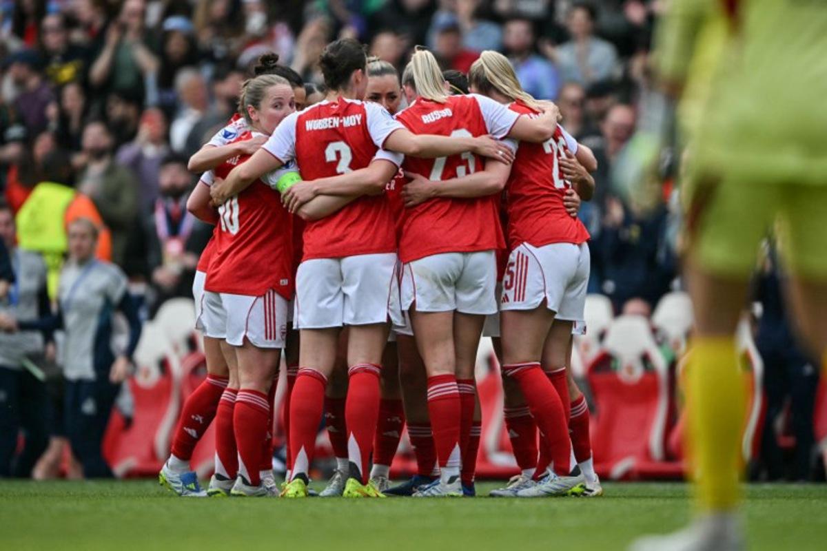 Arsenal players huddle to celebrate their first goal to draw even during the women's UEFA Champions League first-leg semi-final football match between Arsenal and OL Lyonnes at the Emirates Stadium, north London, on April 26, 2026.  Glyn KIRK / AFP