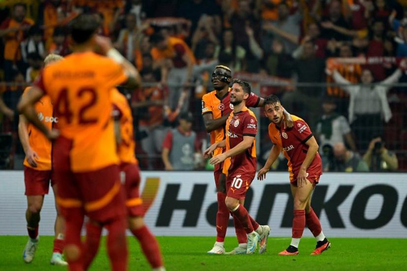 Galatasaray's Turkish forward #11 Yunus Akgun (R) celebrates scoring his team's second goal with Glatasaray's Belgian forward #10 Dries Mertens (2nd-R) and Galatasaray's Nigerian forward #45 Victor Osimhen (C) during the UEFA Europa League 1st round day 1 football match between Galatasaray SK and PAOK FC at the Ali Sami Yen Sports Complex in Sisli, near Istanbul, on September 25, 2024.  Yasin AKGUL / AFP